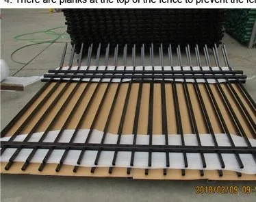 Bent top metal fence panel protected with cardboard for export packing