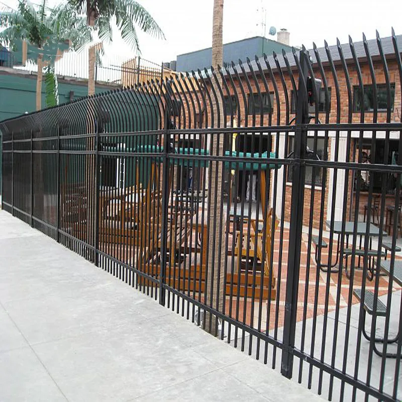 Curved top steel fence installed around a property boundary