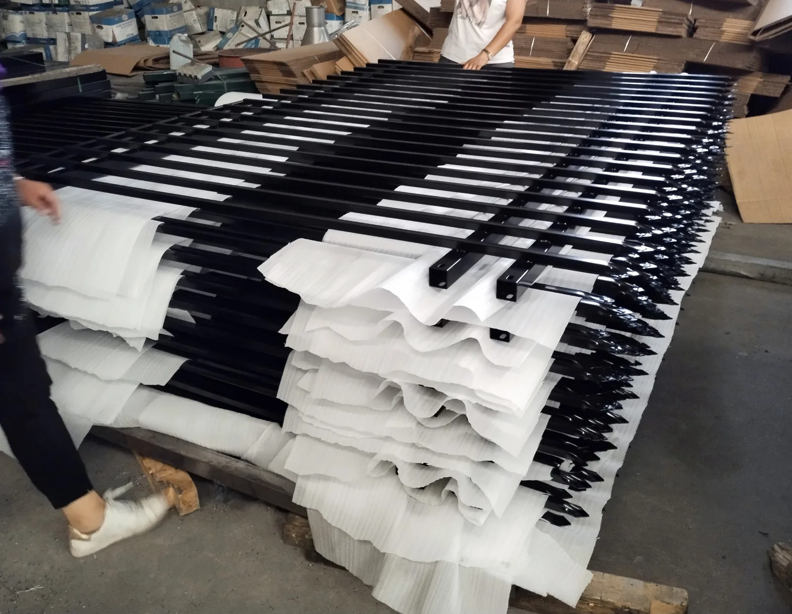Protective material placed between black Pressed Top Steel Fence components