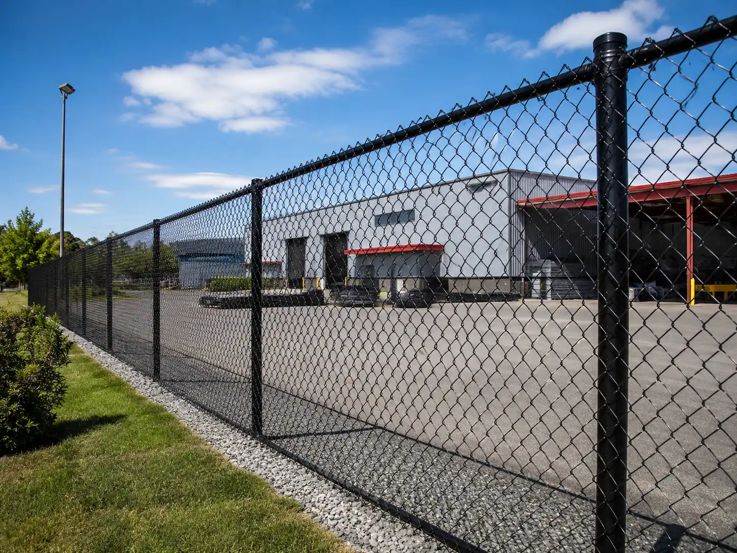 Galvanized steel chain link fence around warehouse and work yard boundary