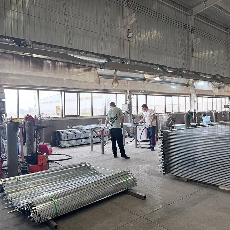 Workers welding fence panels in factory