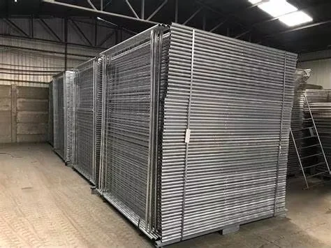 Galvanized Temporary Fence Panels in Warehouse Storage Stacks of galvanized temporary fence panels stored upright inside a warehouse