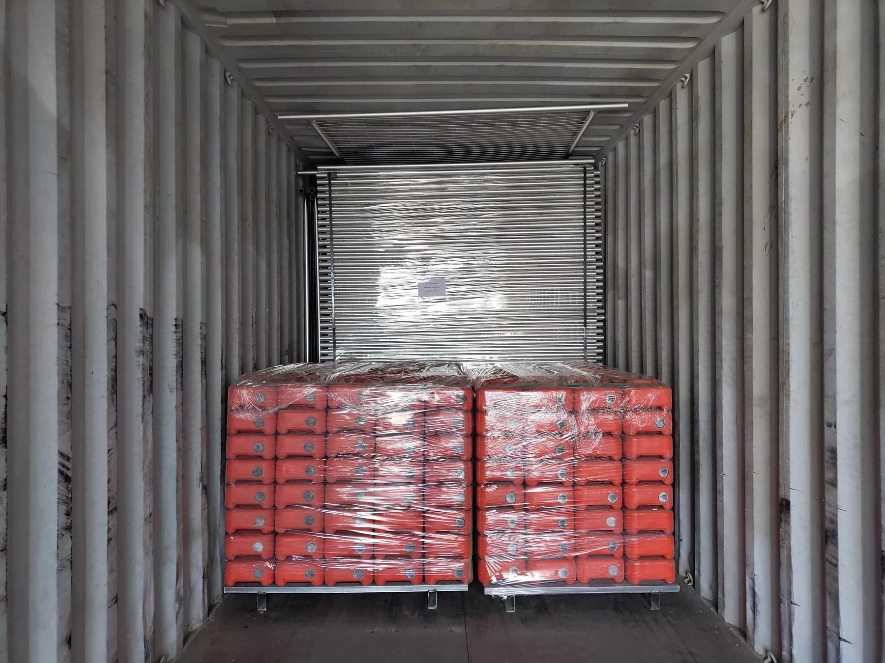 Temporary fence panels and weighted bases secured inside an export container