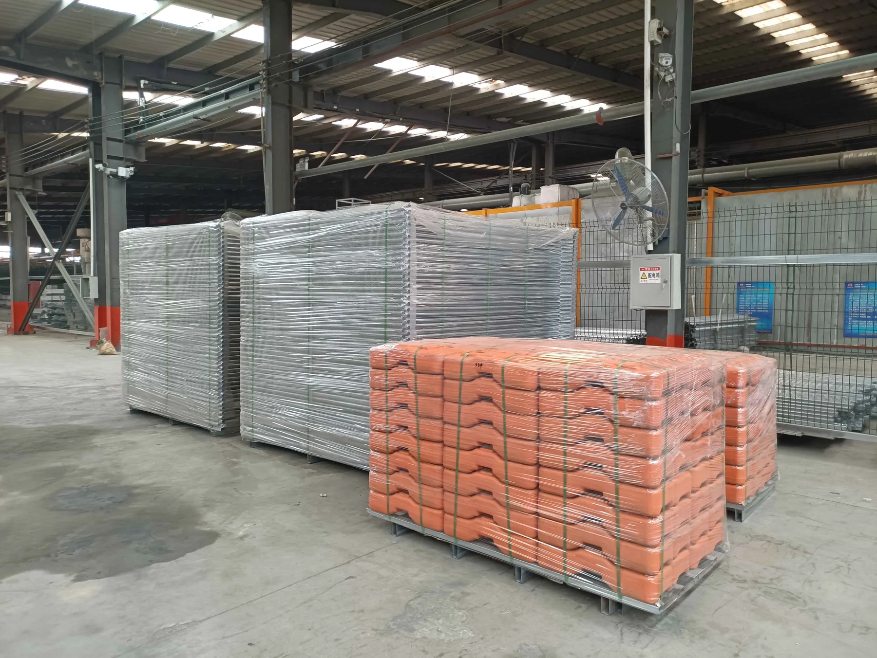 Galvanized fence panels and weighted bases packed in the factory