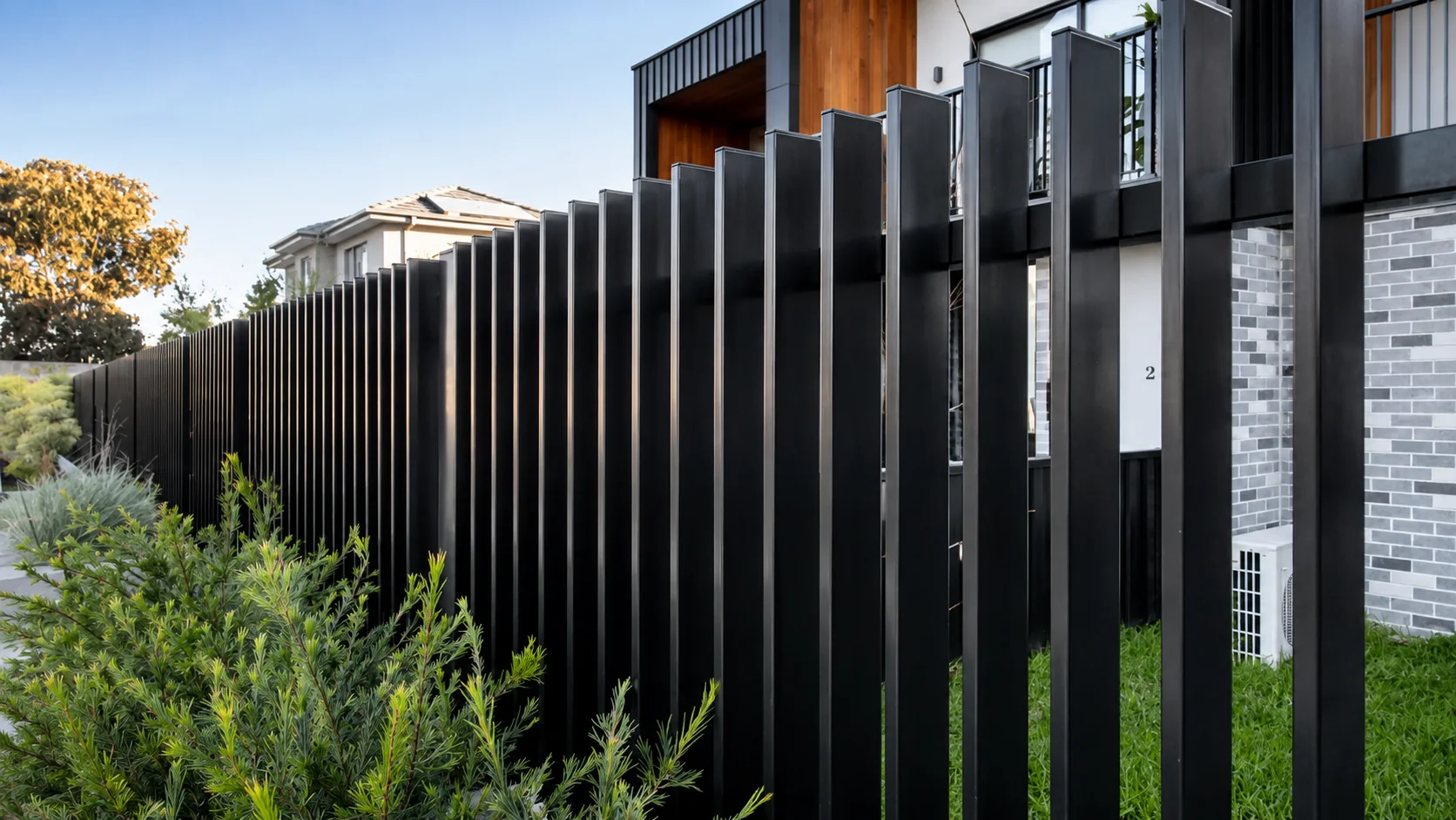 Black modern blade fence installed at an Australian residential property
