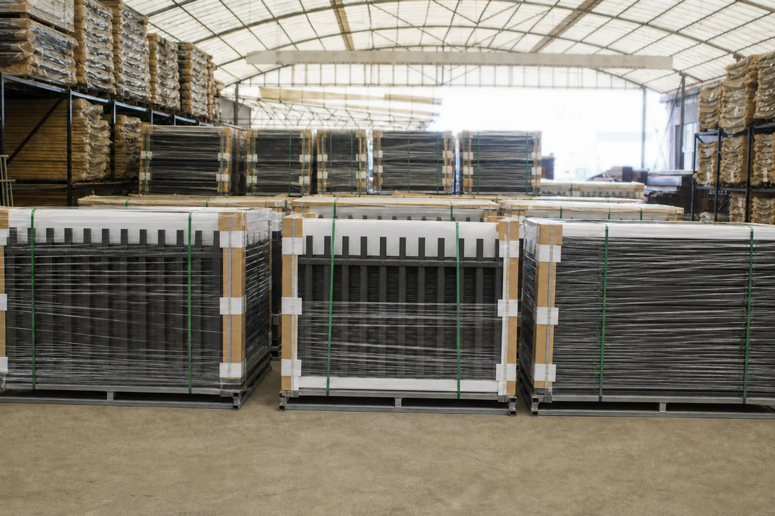 Wrapped steel blade fence panels protected with foam, corner guards and straps on reinforced warehouse pallets