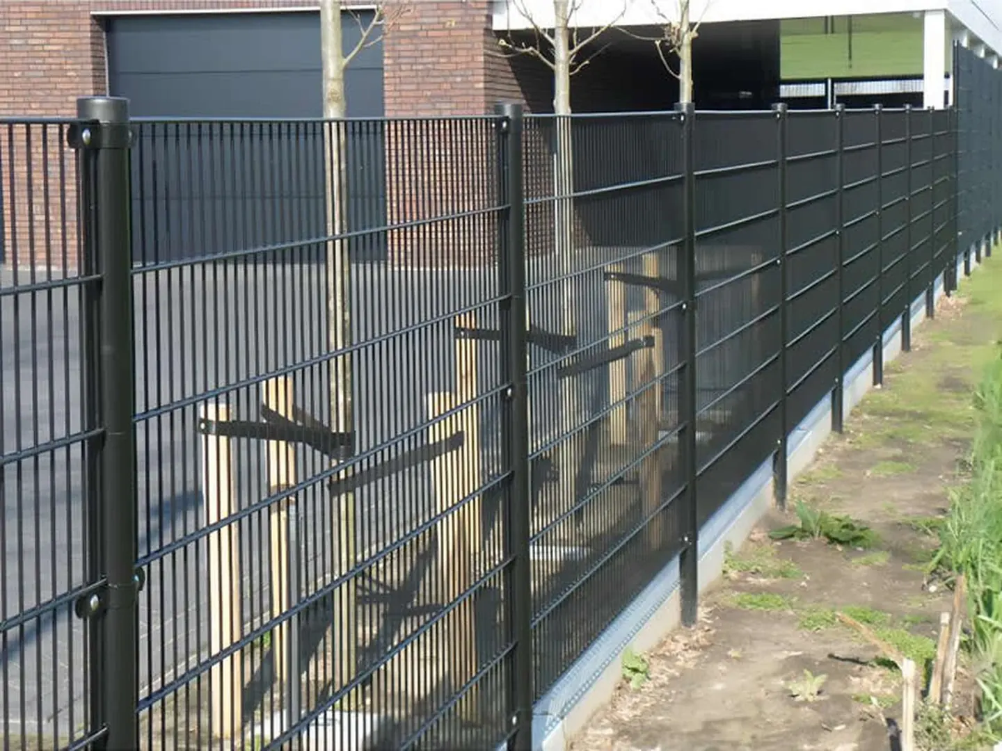 Close view of double wire mesh fence horizontal and vertical wires in a perimeter scene