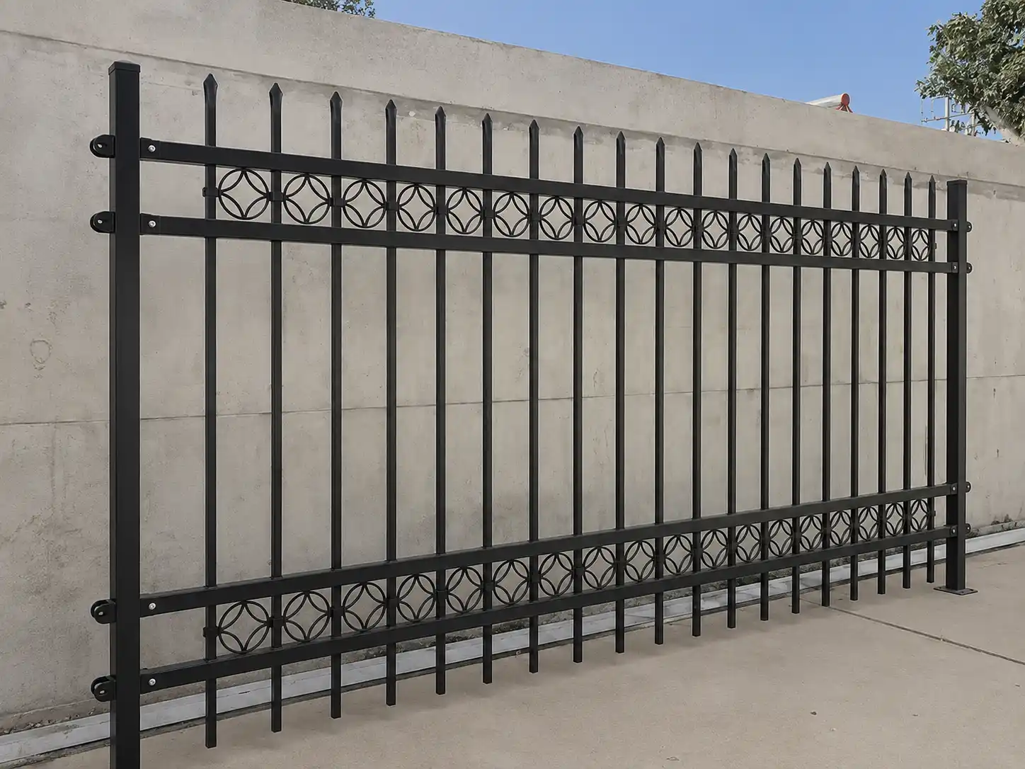 Black steel spear top fence panel with circular ornamental inserts and square posts