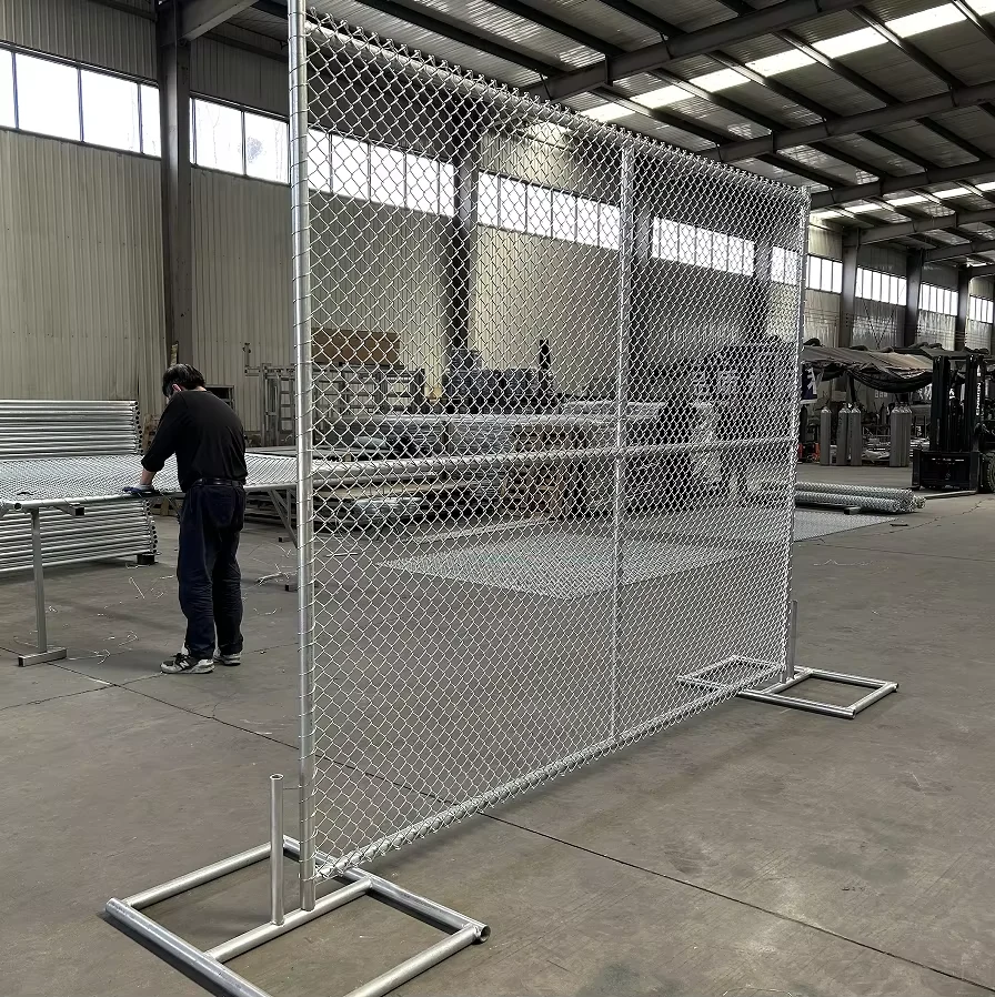 Temporary chain link fence panel standing on twin-socket steel feet during factory inspection