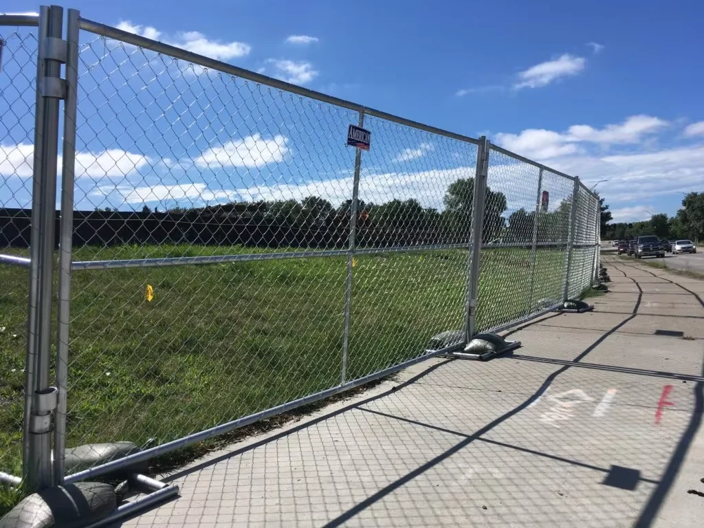 Temporary chain link fence line with weighted feet