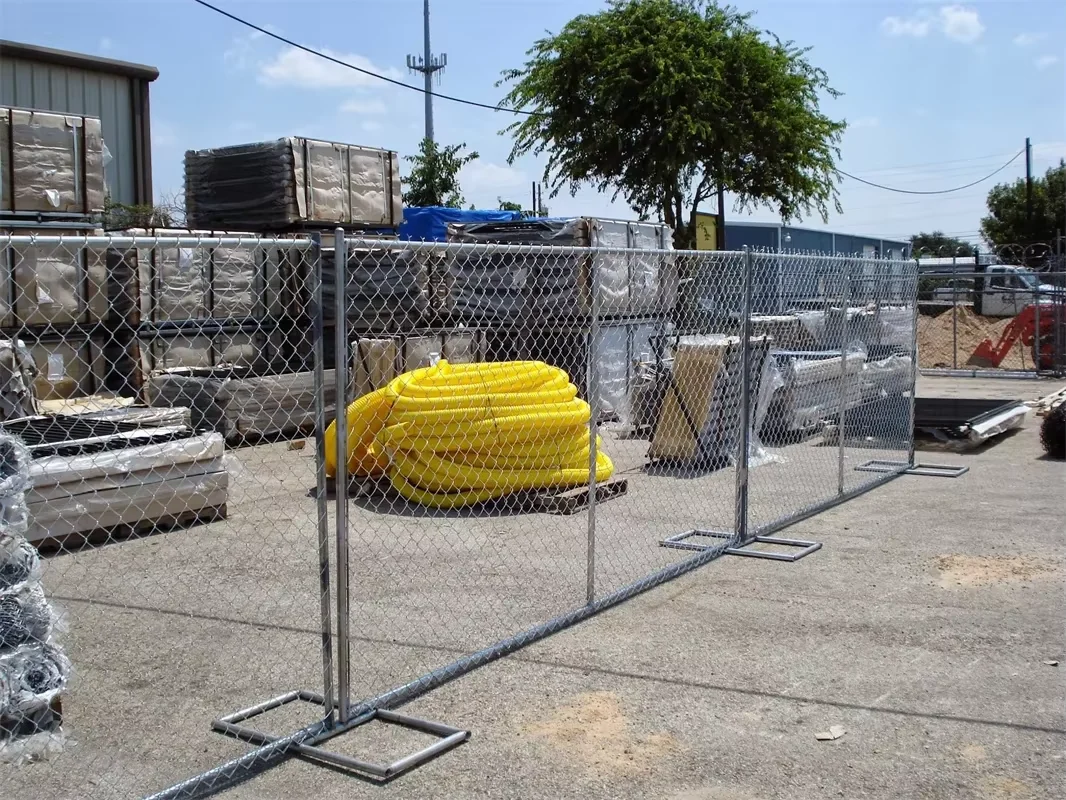 Temporary chain link fence panels installed around a commercial work yard